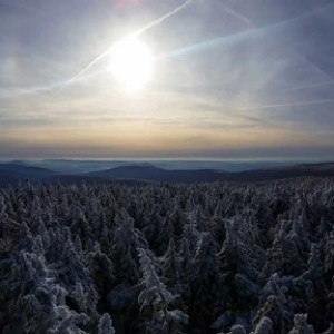 a man standing on top of a snow covered mountain