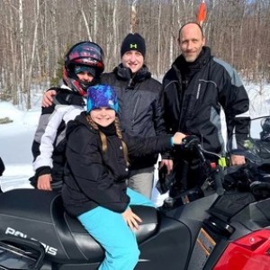 a group of people sitting on a motorcycle