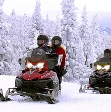 a group of people sitting in the snow
