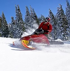 a man riding skis down a snow covered slope