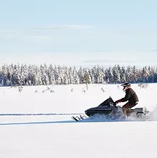 a man riding skis down a snow covered slope
