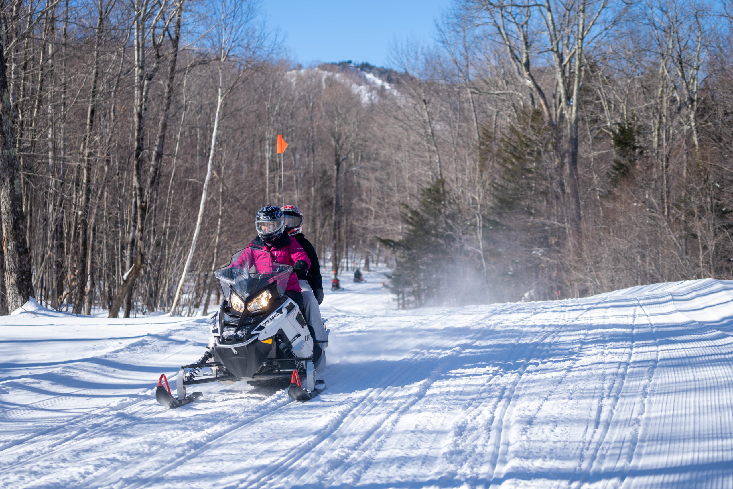 a man riding skis down a snow covered slope